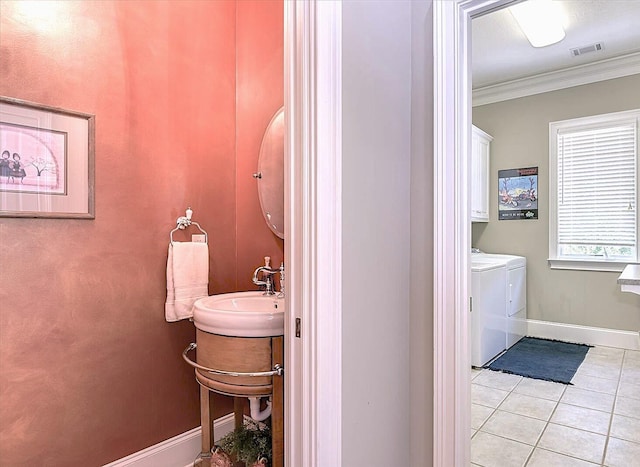 bathroom featuring ornamental molding, tile patterned floors, independent washer and dryer, and vanity