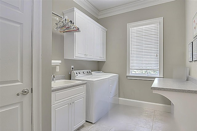 clothes washing area featuring light tile patterned flooring, sink, cabinets, washer and dryer, and ornamental molding