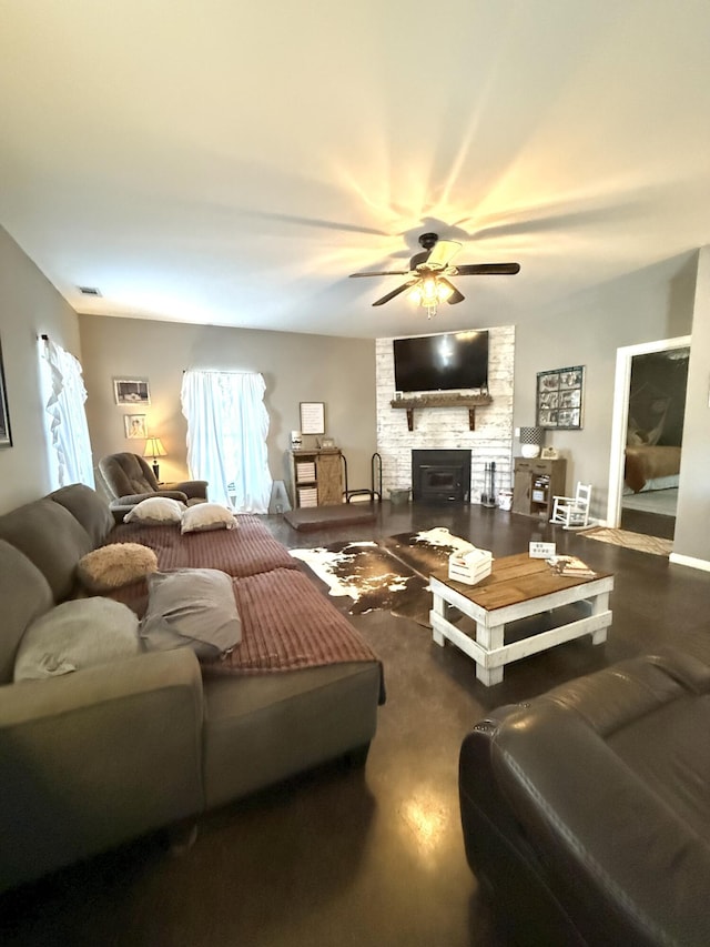 living room featuring ceiling fan and a fireplace