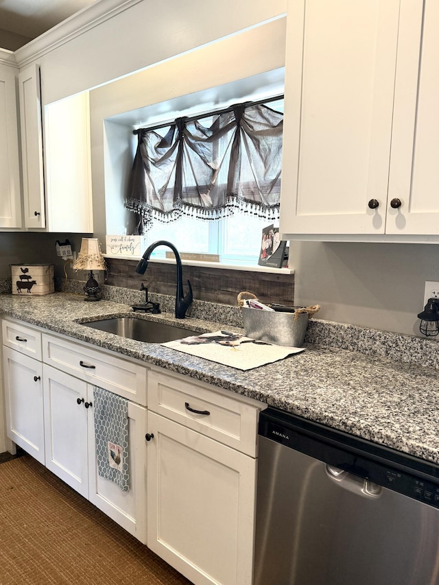 kitchen featuring white cabinetry, sink, ornamental molding, stainless steel dishwasher, and light stone countertops