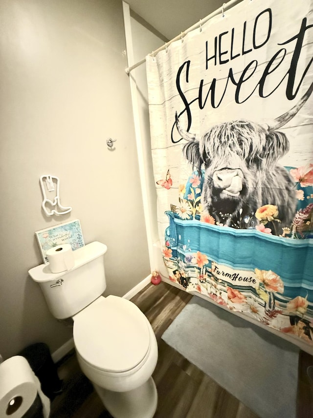 bathroom featuring hardwood / wood-style flooring and toilet