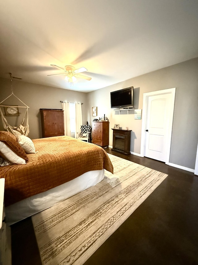 bedroom featuring a fireplace and ceiling fan