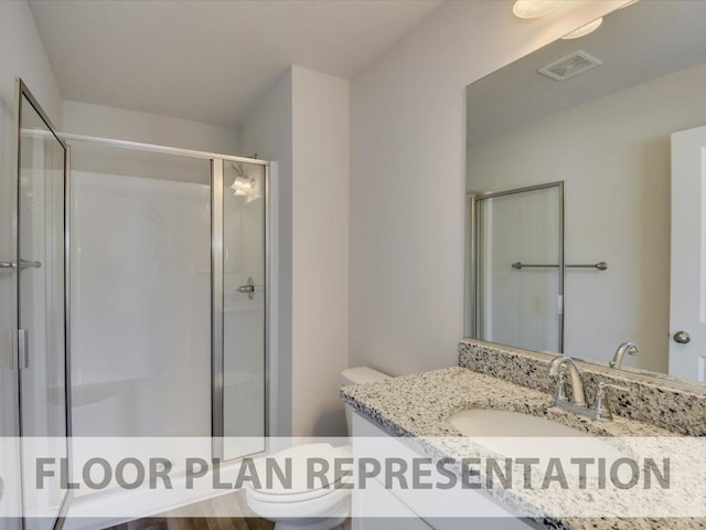 bathroom featuring vanity, hardwood / wood-style flooring, toilet, and an enclosed shower