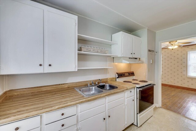 kitchen featuring white cabinetry, white range with electric cooktop, ceiling fan, and sink