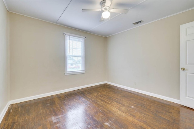 spare room featuring ceiling fan and dark wood-type flooring
