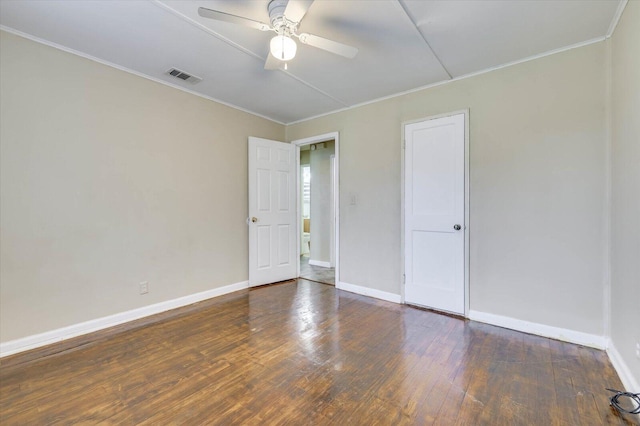 spare room featuring ceiling fan, crown molding, and dark wood-type flooring