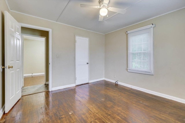 unfurnished bedroom with ceiling fan and dark wood-type flooring