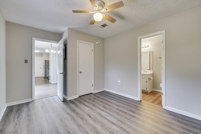 2913 Kings View Dr, Augusta, GA 30909 - unfurnished bedroom featuring light wood-style floors, ceiling fan, ensuite bathroom, and a chandelier