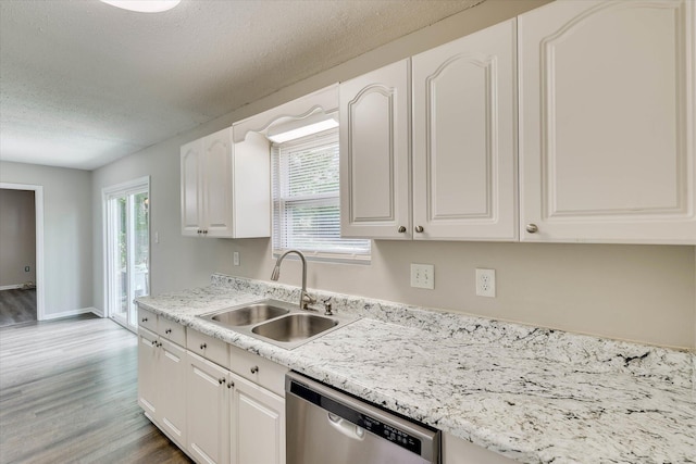 2913 Kings View Dr, Augusta, GA 30909 - kitchen featuring dishwasher, light wood-style flooring, white cabinets, plenty of natural light, and a textured ceiling