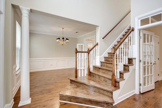 5107 Windmill Pl, Evans, GA 30809 - stairs with ornamental molding, wood finished floors, a chandelier, and decorative columns