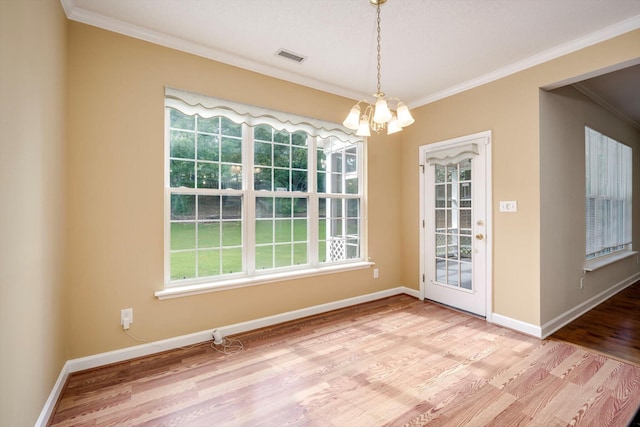 5107 Windmill Pl, Evans, GA 30809 - unfurnished dining area with a chandelier, wood finished floors, and crown molding