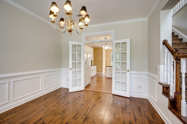 5107 Windmill Pl, Evans, GA 30809 - unfurnished dining area with french doors, a chandelier, dark wood finished floors, stairs, and ornamental molding
