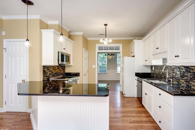 5107 Windmill Pl, Evans, GA 30809 - kitchen featuring stainless steel appliances, light wood-type flooring, tasteful backsplash, white cabinets, and a chandelier