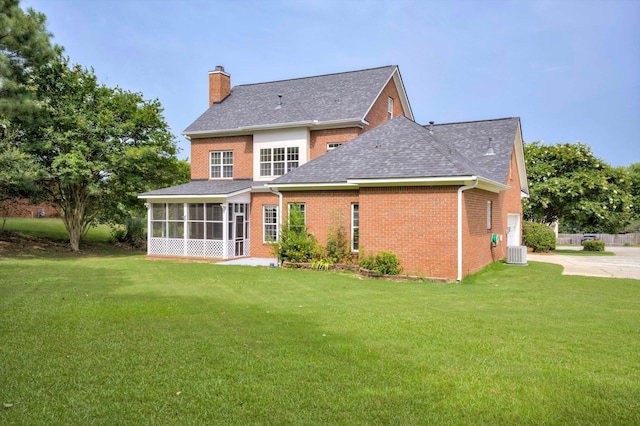 5107 Windmill Pl, Evans, GA 30809 - rear view of house with a sunroom, a chimney, and a lawn