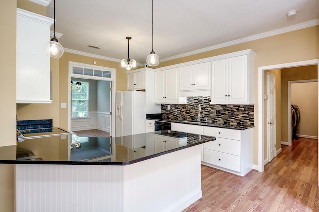 5107 Windmill Pl, Evans, GA 30809 - kitchen with white fridge with ice dispenser, light wood-type flooring, a peninsula, dishwasher, and white cabinets