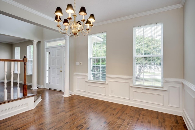 5107 Windmill Pl, Evans, GA 30809 - entryway featuring a wainscoted wall, ornate columns, wood finished floors, crown molding, and a chandelier