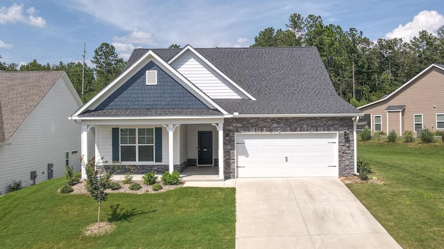 craftsman inspired home featuring a porch, a garage, and a front yard