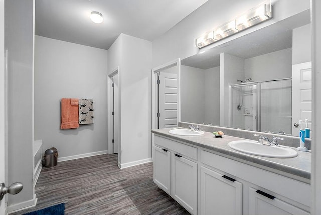 3076 White Gate Loop, Aiken, SC 29801 - bathroom featuring a shower stall, double vanity, and wood finished floors