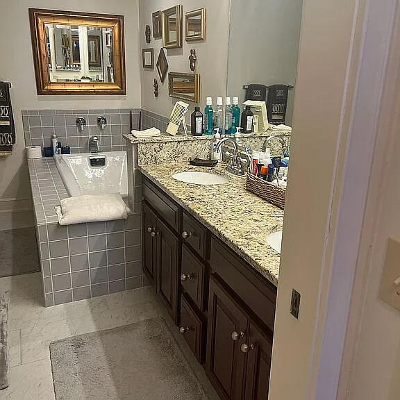 bathroom featuring a bath, vanity, and tile patterned floors