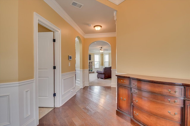 3051 Parkridge Dr, Grovetown, GA 30813 - hall featuring a wainscoted wall, light wood finished floors, ornamental molding, and arched walkways