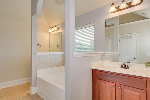 3051 Parkridge Dr, Grovetown, GA 30813 - full bathroom with a bath, vanity, baseboards, and lofted ceiling