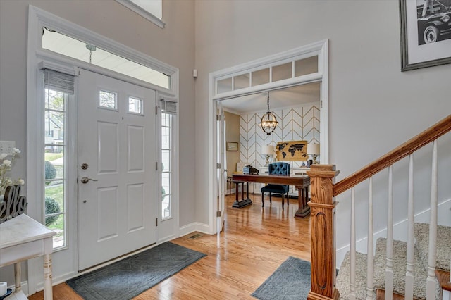 4002 Backwater Ct, Evans, GA 30809 - entrance foyer with visible vents, an accent wall, an inviting chandelier, light wood-style floors, and stairs