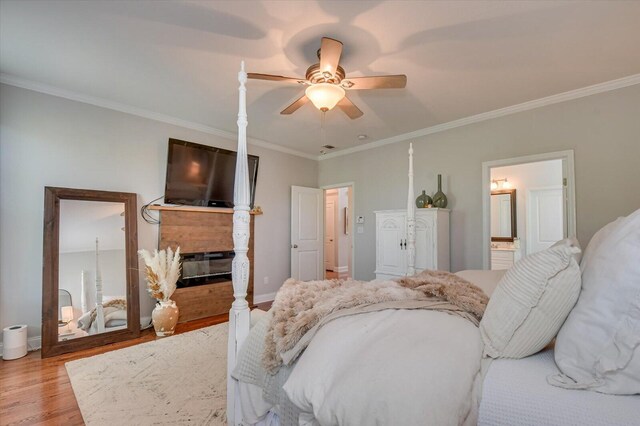 4002 Backwater Ct, Evans, GA 30809 - bedroom featuring crown molding, light wood finished floors, baseboards, and a glass covered fireplace