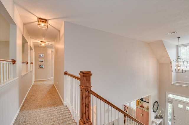 4002 Backwater Ct, Evans, GA 30809 - hall with a notable chandelier, baseboards, an upstairs landing, visible vents, and carpet