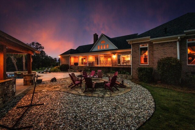 698 Heggies Ridge Dr, Appling, GA 30802 - rear view of house with a patio, a chimney, and an outdoor fire pit