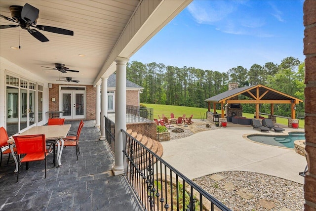 698 Heggies Ridge Dr, Appling, GA 30802 - view of patio with french doors, a gazebo, an outdoor living space with a fire pit, outdoor dining area, and a ceiling fan