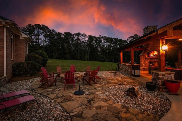 698 Heggies Ridge Dr, Appling, GA 30802 - view of patio / terrace with a warm lit fireplace and an outdoor fire pit