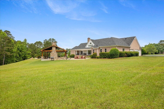 698 Heggies Ridge Dr, Appling, GA 30802 - view of front of home featuring a gazebo, a front lawn, a chimney, and a garage