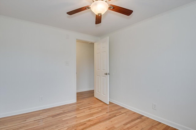 spare room featuring crown molding, ceiling fan, and light wood-type flooring