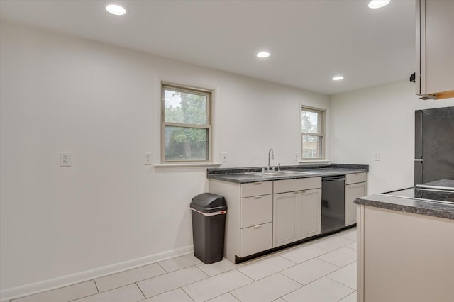 kitchen featuring light tile patterned flooring, dishwasher, and sink