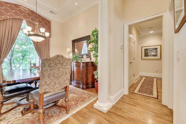 sitting room with crown molding, an inviting chandelier, hardwood / wood-style floors, and decorative columns