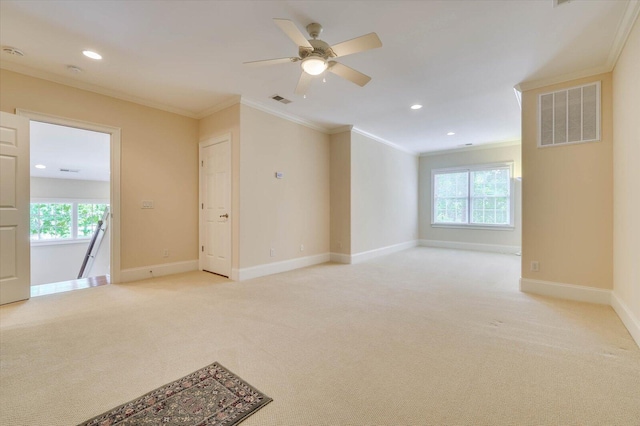 unfurnished room with ornamental molding, light carpet, and ceiling fan