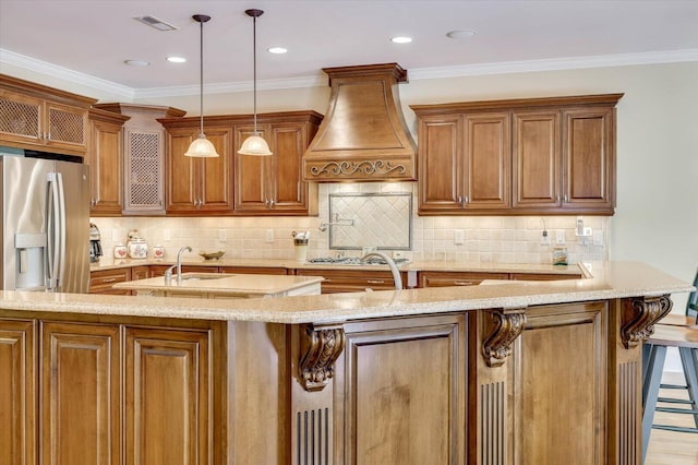 kitchen with decorative light fixtures, a kitchen breakfast bar, custom exhaust hood, stainless steel appliances, and light stone countertops