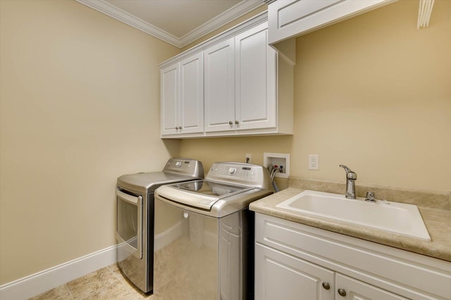 clothes washing area with light tile patterned floors, sink, crown molding, cabinets, and washing machine and clothes dryer