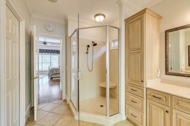 bathroom featuring tile patterned flooring, ornamental molding, vanity, and an enclosed shower