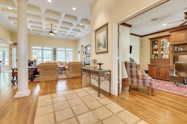 interior space with ornate columns, coffered ceiling, ceiling fan, and light wood-type flooring