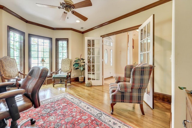 home office with crown molding, light hardwood / wood-style flooring, and ceiling fan