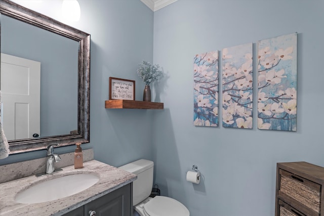 half bath featuring ornamental molding, toilet, and vanity