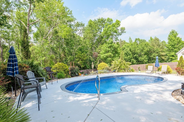 view of pool featuring a patio and fence