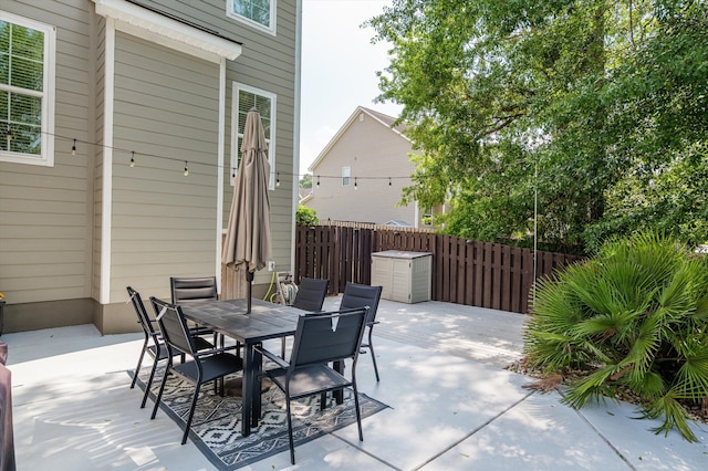 view of patio featuring fence and outdoor dining area
