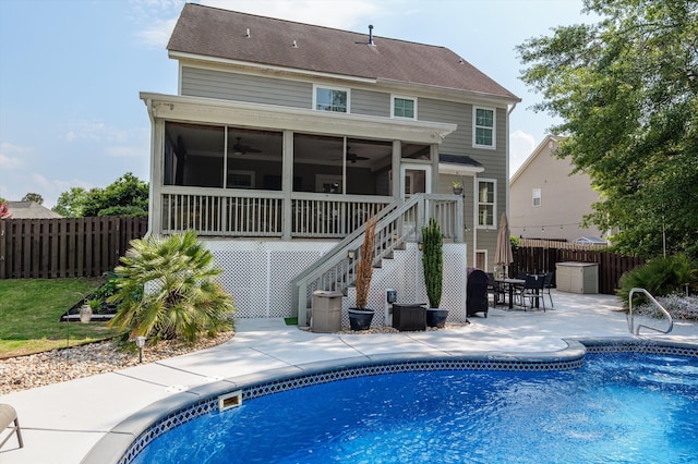 back of house with a sunroom, ceiling fan, stairs, and a patio