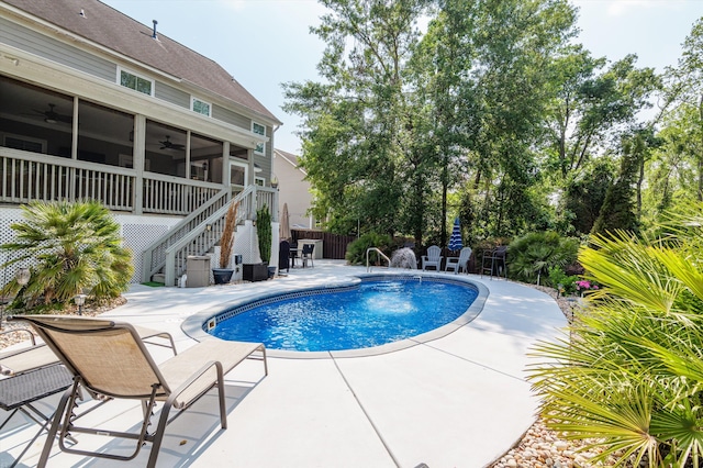 view of pool featuring ceiling fan, stairs, a patio, and fence
