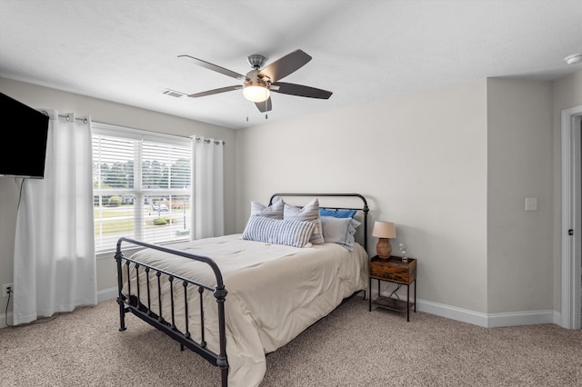 bedroom featuring baseboards, light carpet, and a ceiling fan