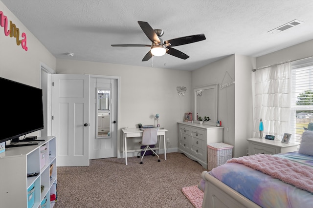 bedroom featuring carpet flooring, a textured ceiling, and ceiling fan