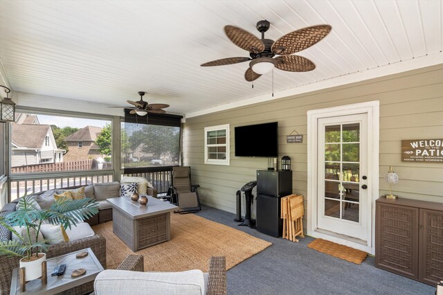 sunroom with a ceiling fan and outdoor lounge area