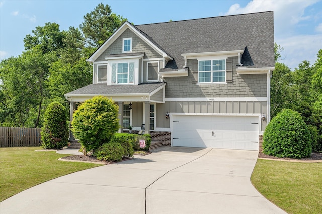 craftsman-style home featuring board and batten siding, a porch, driveway, an attached garage, and a shingled roof